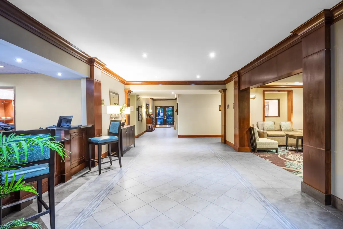 A welcoming front desk area with comfortable seating and a view of the entrance, creating a sense of arrival and comfort. The space appears organized, friendly, and well-suited for guests transitioning between activities.